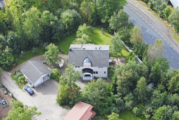 Saulin komean kivitalon kruunaa puutarha, jossa on suihkulähde.