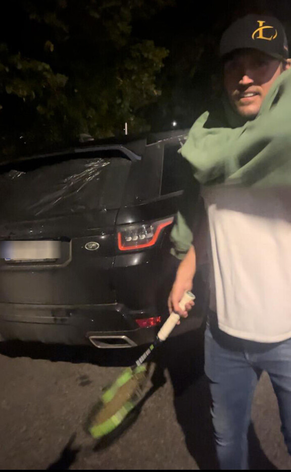 Stefu heilutti tennismailaa taksikuskin edessä. Taustalla hänen hajottamansa Range Rover, joka on kulkeutunut Hangosta Helsinkiin.