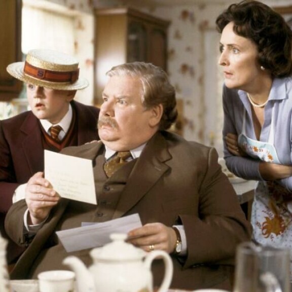Richard Griffiths (1947–2013) oli Vernon Dursley. Hänen vierellään on Dudley-poika (Harry Melling), sekä Petunia-vaimo (Fiona Shaw). Sisäkuva