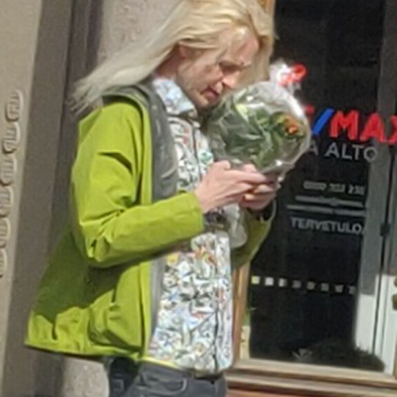 Petrus räpläsi puhelintaan kukkakimppu kädessä ja tukka hulmuten. Petrus Pennanen