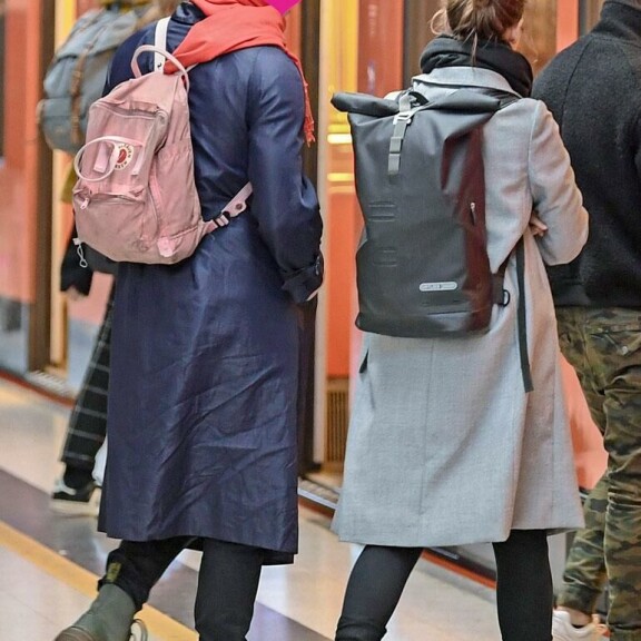 Pari hyppäsi itään päin menevään metroon. Lin miehellä oli vaaleanpunainen reppu. Pari hyppäsi itään päin menevään metroon. Lin miehellä oli vaaleanpunainen reppu.