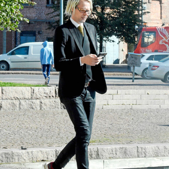 Raptori-bändin Jufosta tuli asiallinen pukumies: tältä legendaarinen rastapää näyttää nykyään - kuva! Jufo keskittyi puhelimeensa.